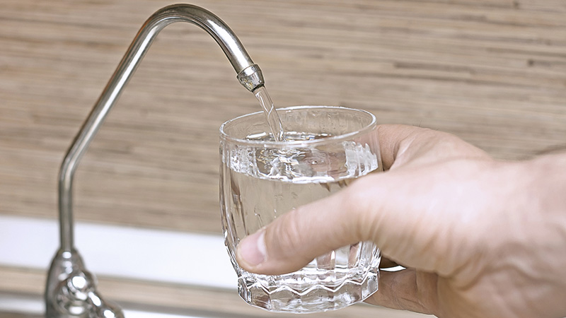 Tap water being tested while performing home inspection services 