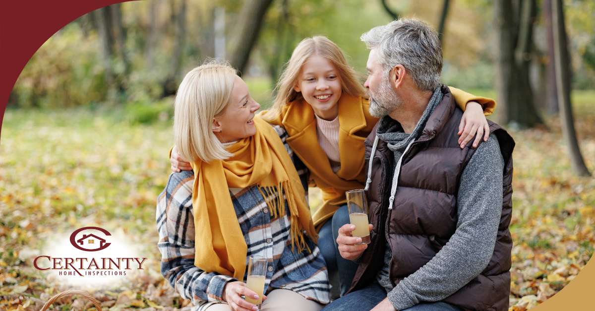 Family enjoying a fall picnic outdoors, smiling and bonding together