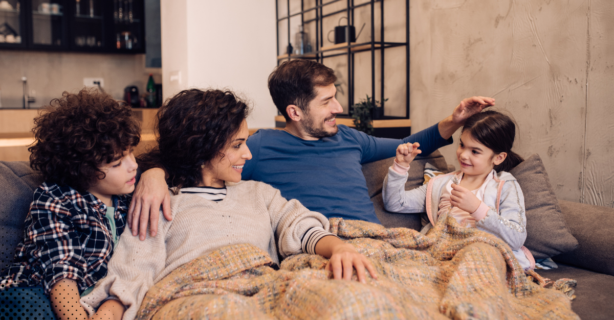 Family relaxing together on the couch at home.