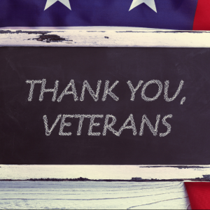 Chalkboard with 'Thank You, Veterans' message, surrounded by an American flag