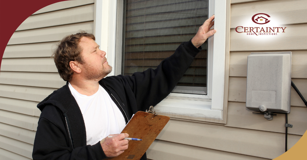 Home inspector examining the exterior window frame with a clipboard in hand.